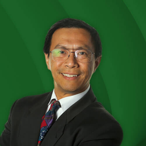 A headshot of Bao Tran, who is an Asian man, smiling directly into the camera. He is wearing a black jacket, a white button down shirt, a colorful tie and glasses.